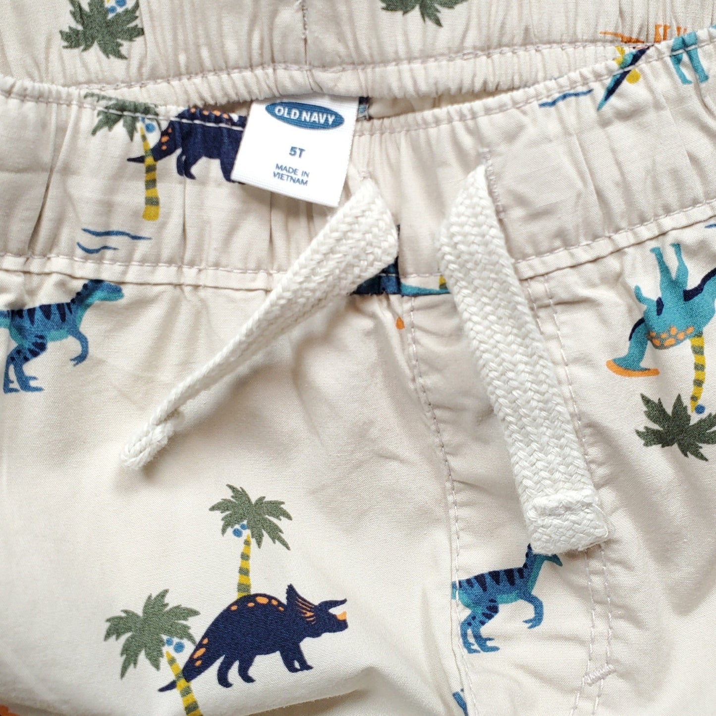 Old Navy Boys Cream Dino Shorts 5T Used, close-up
